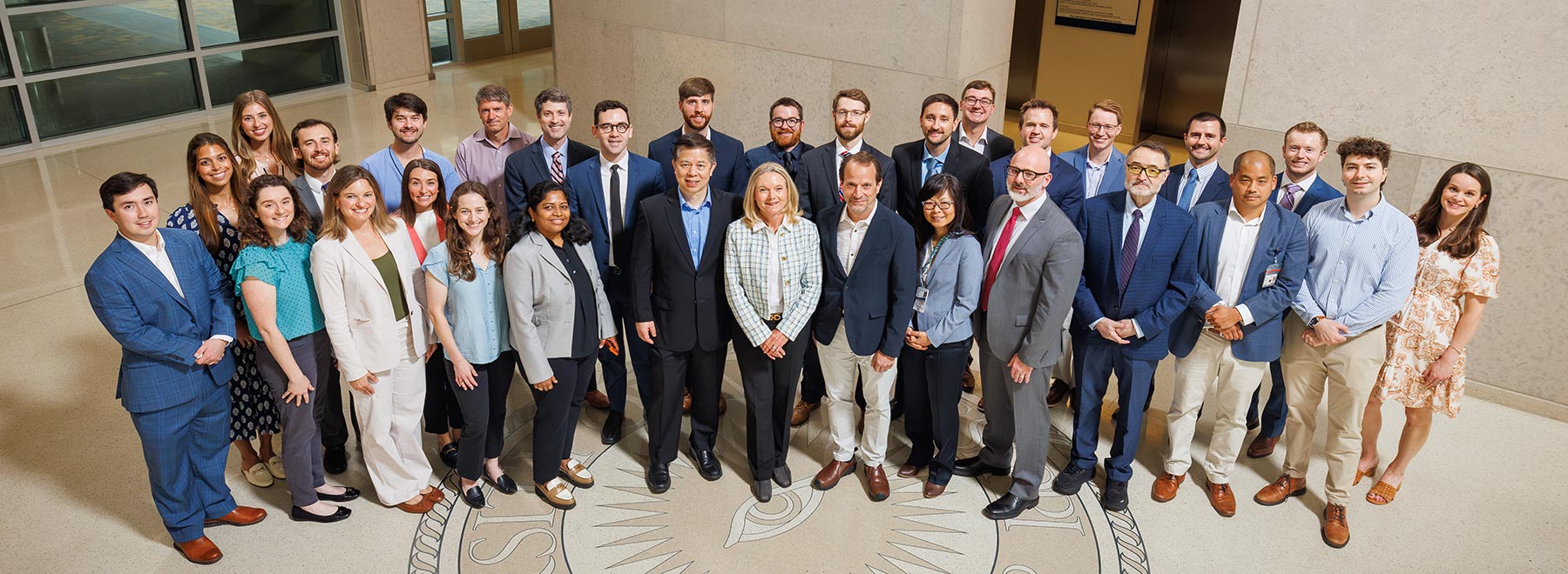 Group portrait of 31 members of the Department of Ophthalmology inside the School of Medicine.